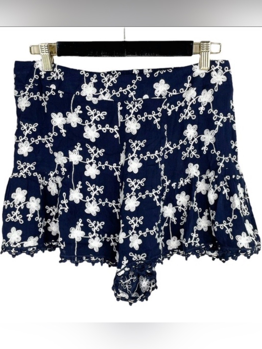 Altar'd State navy blue shorts featuring white floral embroidery